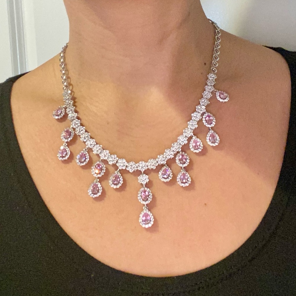 Graduated CZ teardrop necklace w/inlaid pink teardrop sapphire stones.